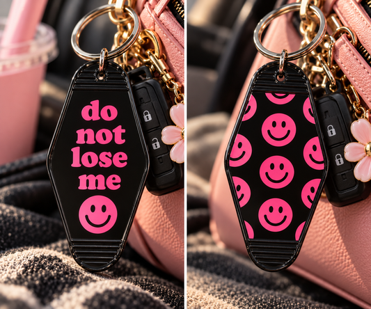 Black Do Not Lose Me double-sided motel keychain with bright pink lettering and pink smiley face pattern on back