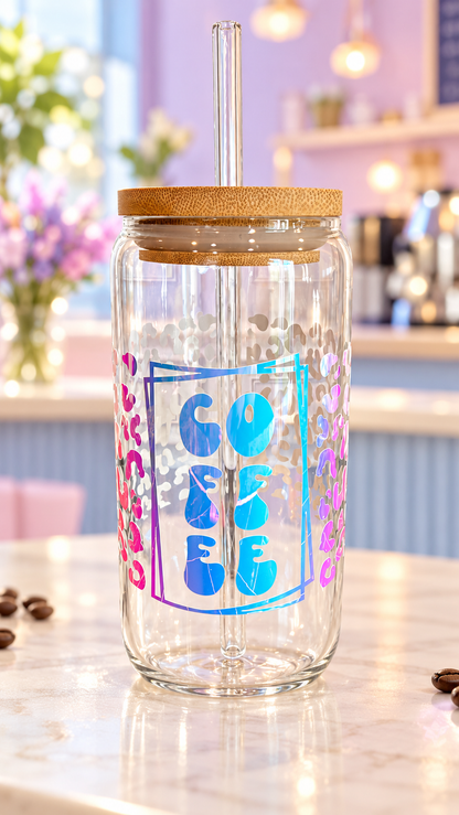 Clear glass tumbler with reflective stacked COFFEE lettering, overlapping rectangular outlines, and leopard print accents, with bamboo lid and glass straw.