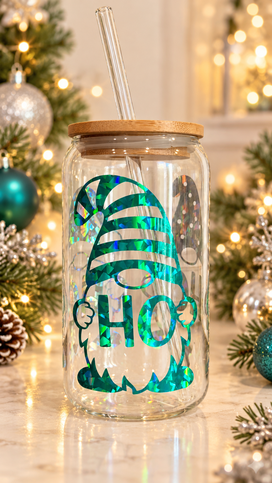 Clear glass tumbler with holographic Christmas gnomes holding HOHOHO lettering, including a teal-green striped-hat gnome, with bamboo lid and glass straw.