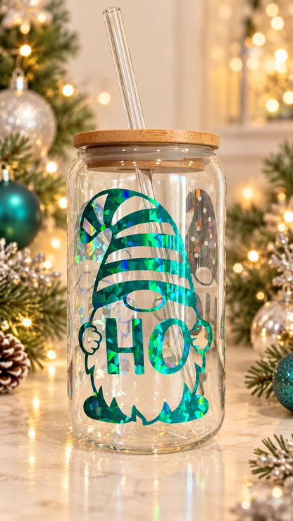 Clear glass tumbler with holographic Christmas gnomes holding HOHOHO lettering, including a teal-green striped-hat gnome, with bamboo lid and glass straw.