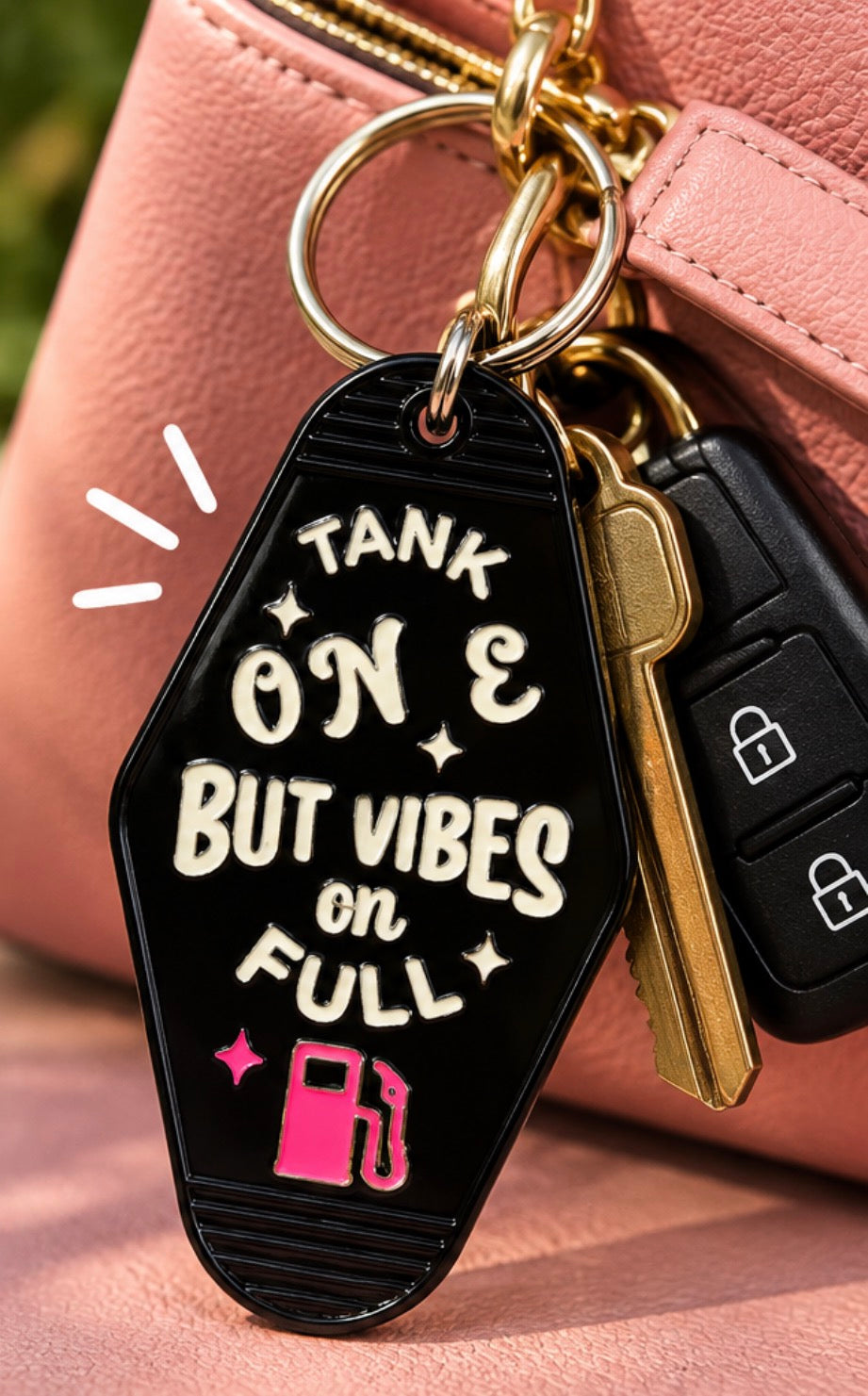 Black Tank on E But Vibes on Full motel keychain with cream lettering and pink gas pump, showing double-sided design