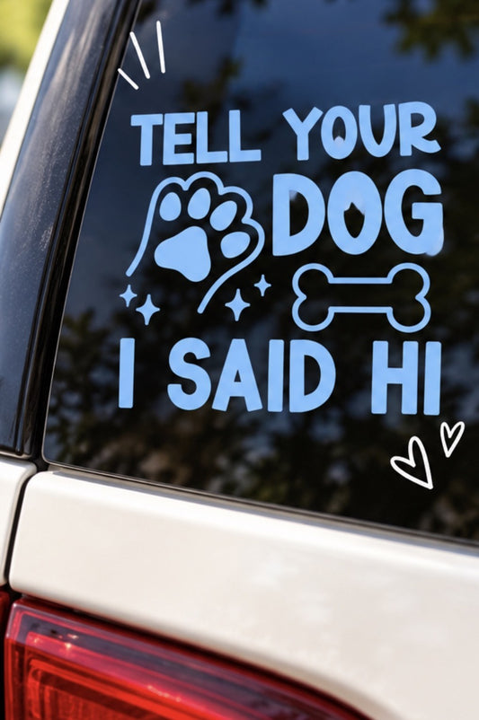 Blue Tell Your Dog I Said Hi vinyl decal with a paw print, bone, and sparkle accents, displayed on white backing.