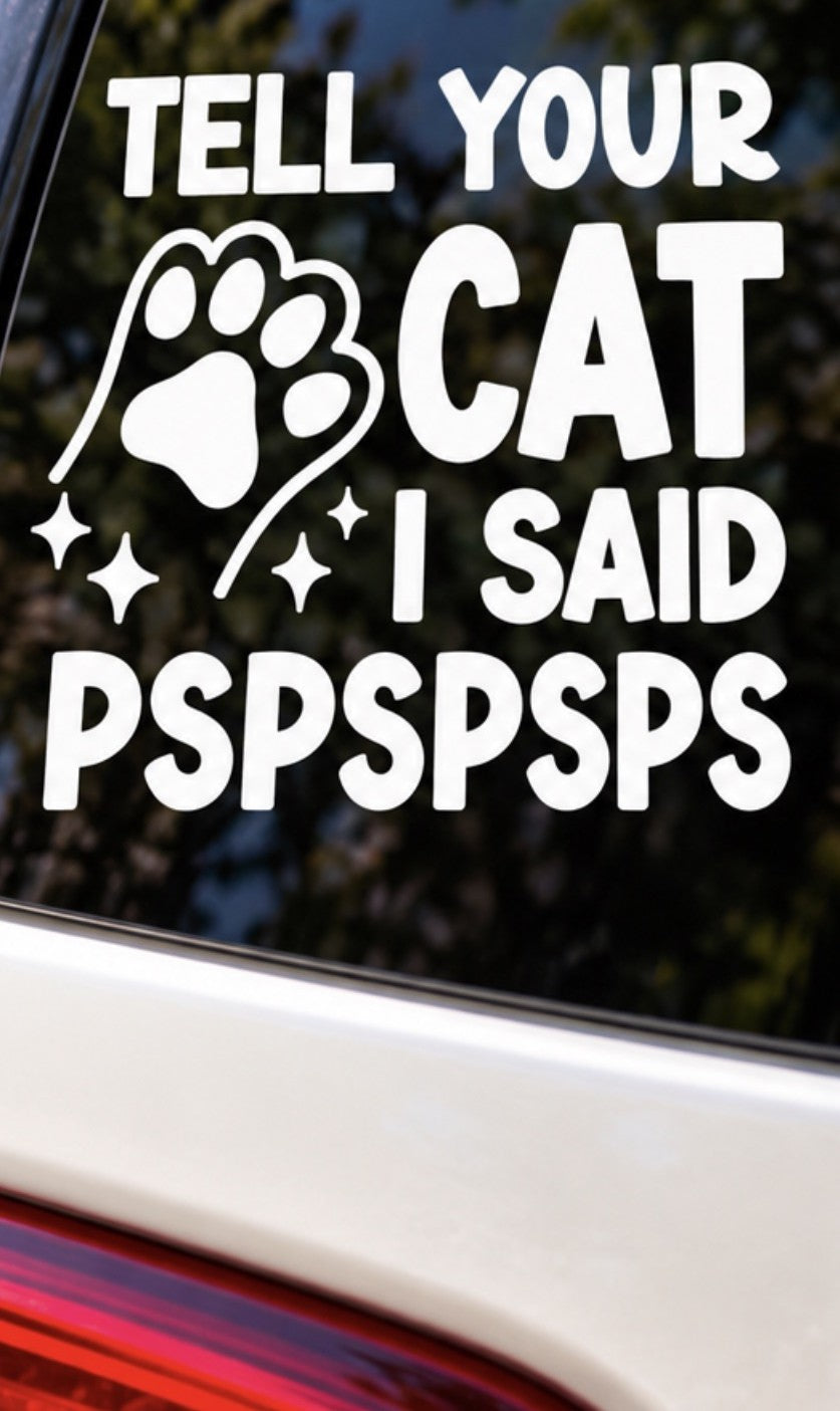 White Tell Your Cat I Said Pspspsps vinyl decal with a paw print and sparkle accents on a car window.