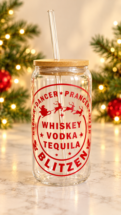 Clear glass tumbler with red Santa sleigh and reindeer artwork, Whiskey Vodka Tequila lettering, and Blitzen text, with bamboo lid and glass straw.