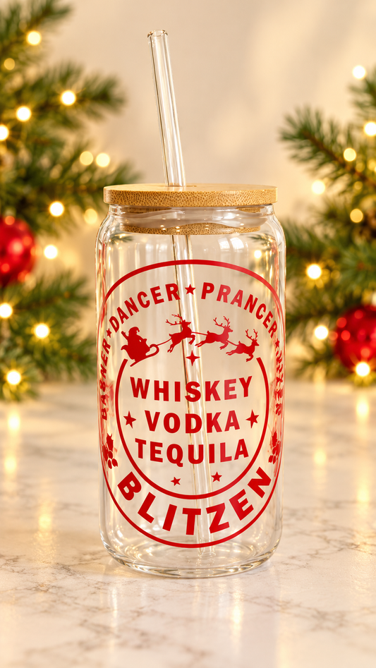Clear glass tumbler with red Santa sleigh and reindeer artwork, Whiskey Vodka Tequila lettering, and Blitzen text, with bamboo lid and glass straw.